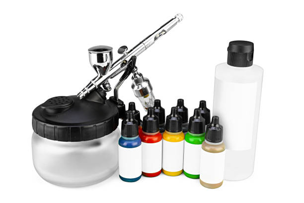 professional airbrush starter set equipment with chrome metal gun acrylic paint and thinner bottles isolated white background. Industry hobby and art concept. professional airbrush starter set equipment with chrome metal gun acrylic paint and thinner bottles isolated on white background. Industry hobby and art concept. airbrush stock pictures, royalty-free photos & images