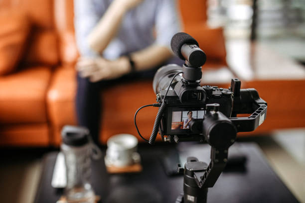 Professional camera filming a video podcast Influencer  recording a video with professional camera, focus on foreground sound recording equipment stock pictures, royalty-free photos & images