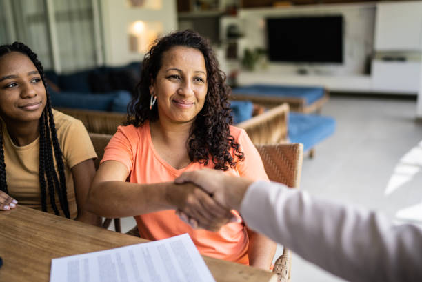 Professional consultant handshake with customer during a home visit stock photo