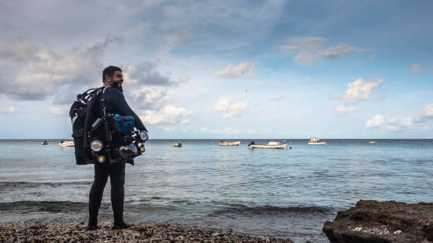 Professional diver, underwater cinematographer before start filming in coral reef of Caribbean Sea around Curacao stock photo