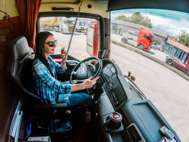 Professional femele truck driver CB talking stock photo
