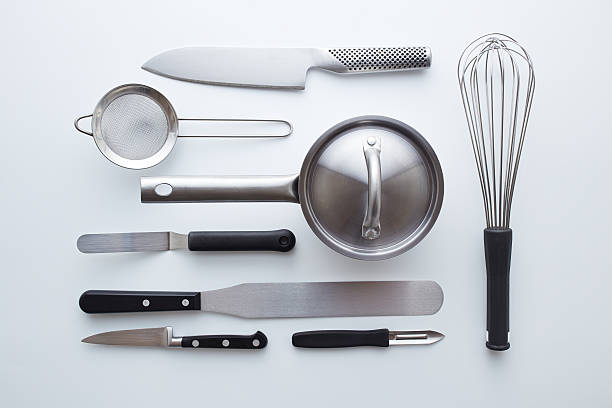 professional kitchen utensils on white background - keukengereedschap stockfoto's en -beelden