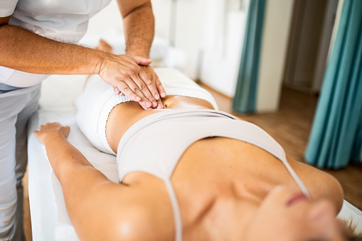 Professional masseur doing therapeutic massage with pressure points