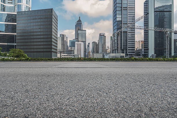Professional use auto advertising backplate empty asphalt road with central district of Hong Kong on background,China. urban road stock pictures, royalty-free photos & images