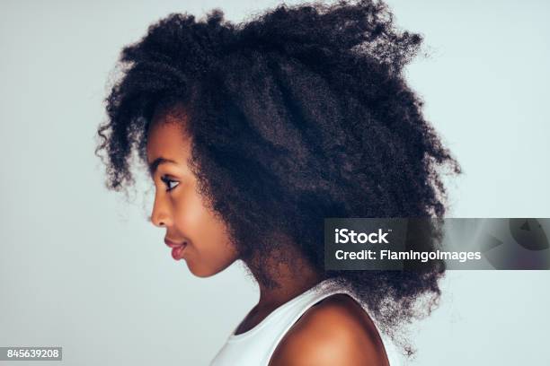 Profile of a cute little African girl with curly hair