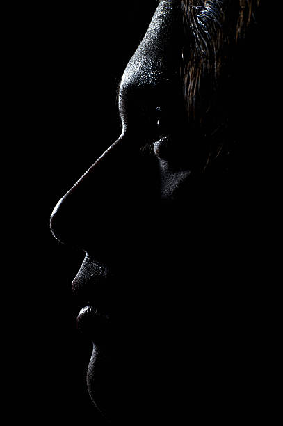 Profile of a young Caucasian male face in the dark portrait of young man chiaroscuro stock pictures, royalty-free photos & images