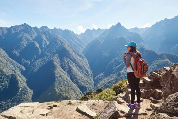 Profile of hiking woman Profile of hiking woman stand on mountain cliff peru girl stock pictures, royalty-free photos & images