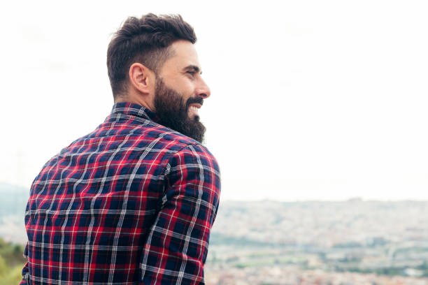 profile portrait of a handsome bearded man smiling profile portrait of a handsome bearded man smiling, concept of beauty and masculinity, copy space for text macho stock pictures, royalty-free photos & images