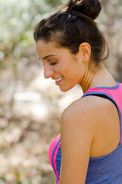 Profile portrait of smiling beauty posing on nature trail stock photo