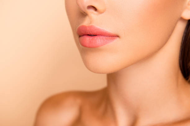 Profile side view cropped close up photo of dreamy sweet well-gr Profile side view cropped close up photo of dreamy sweet well-groomed lady with her shoulder she isolated on pastel beige background stand half turn to camera focus on lips human mouth stock pictures, royalty-free photos & images