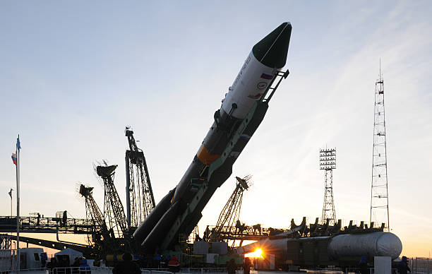 Progress Space Vehicle Elevation "Baikonur, Kazakhstan - January 26, 2011: Progress cargo spacecraft is being elevated on the launch tower at sunrise two days before launch" baikonur stock pictures, royalty-free photos & images