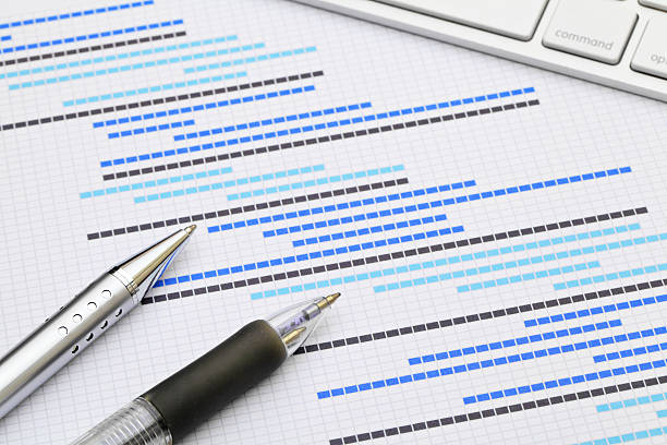 Project Estimation with Pens and keyboard stock photo