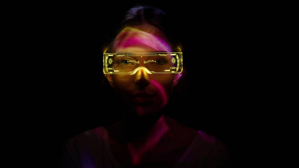 projection on a woman's face wearing futuristic glasses - metaverse imagens e fotografias de stock