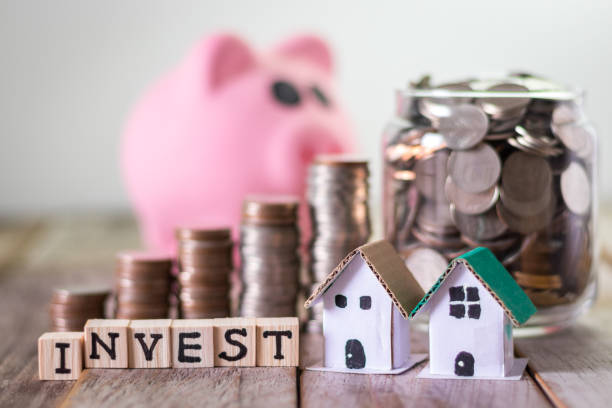 Property investment Home investment, saving money for mortgage, coins in a glass jar on wooden table background Investment Properties stock pictures, royalty-free photos & images