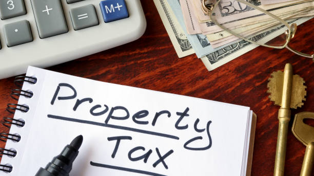 Property tax written in a notebook and calculator.  Property Tax stock pictures, royalty-free photos & images