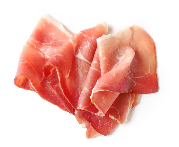 prosciutto slice isolated on a white background, top view prosciutto slice isolated on a white background, top view canape photos stock pictures, royalty-free photos & images