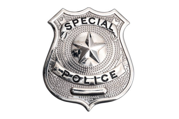 Protect and serve, law enforcement agent and blue lives matter concept with shiny metallic police officer badge isolated on white background with clipping path cutout stock photo