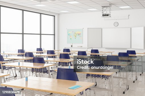 istock Protective Face Masks And Hand Sanitizers On The Desks According To New Normal Concept In An Empty Classroom. 1290836478