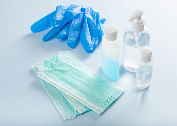 protective medical mask, gloves and sanitizer disinfecting gel. protective measures against virus, bacteria protective medical mask, gloves and sanitizer disinfecting gel. protective measures against virus, bacteria protective workwear stock pictures, royalty-free photos & images