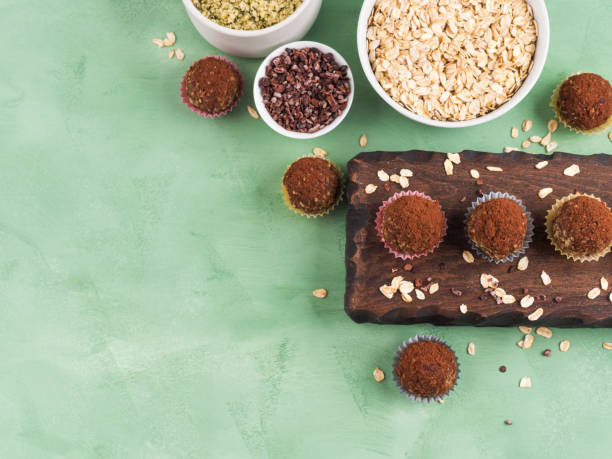 Protein energy balls with cocoa and seeds Protein energy balls with cocoa, dried fruit, nut butter and seeds. Healthy dessert, snack, flat lay plasma ball stock pictures, royalty-free photos & images