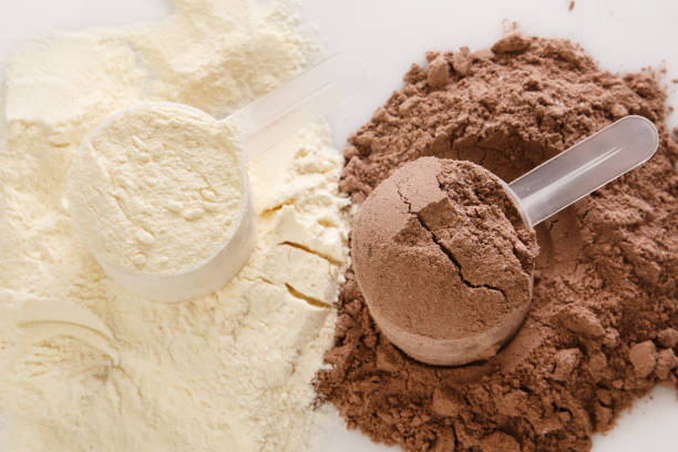 Protein powder Close up of protein powder and scoops protein photos stock pictures, royalty-free photos & images