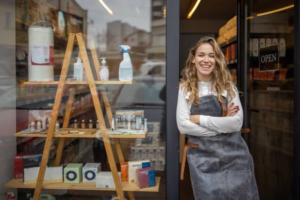 Proud female small business owner in front of the store stock photo