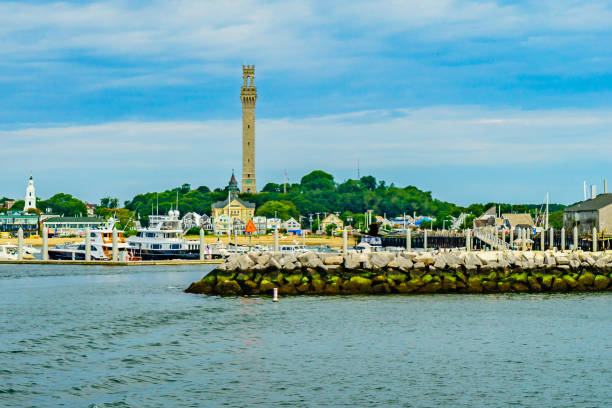 Provincetown Marina and Pilgrim Monument, Provincetown MA US Provincetown Marina and Pilgrim Monument, Provincetown MA US. pilgrims monument stock pictures, royalty-free photos & images