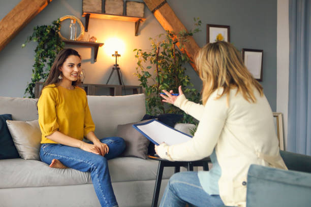 Psychologist having session with her female patient stock photo