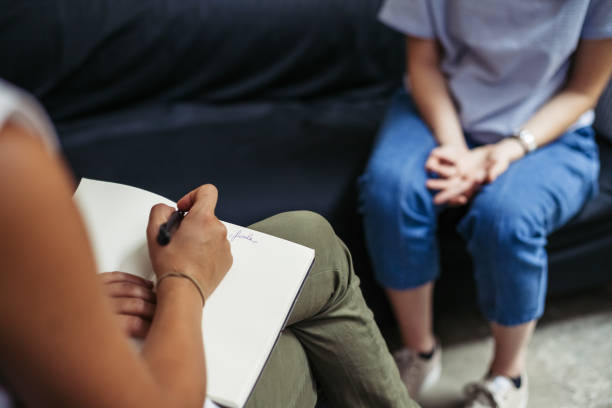 Psychotherapy session, woman talking to his psychologist in the studio  counseling stock pictures, royalty-free photos & images