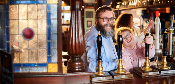 pub landlord and happy staff - saki baba stok fotoğraflar ve resimler