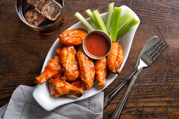 Pub Style Chicken Wings A serving of delicious spicy buffalo chicken wings on a pub style restaurant table top. buffalo new york stock pictures, royalty-free photos & images