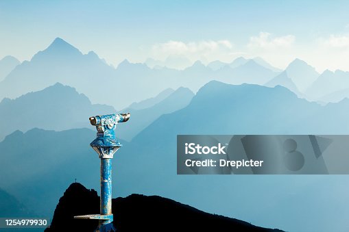 istock Public binoculars and Mountain Silhouettes at Sunrise. Foresight and vision for new business concepts and creative ideas. Alps, Allgau, Bavaria, Germany. 1254979930