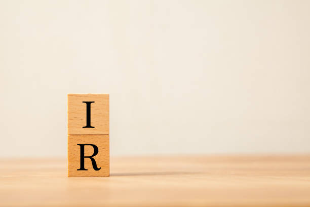 Public relations for investors. IR. Investor Relations. IR letters drawn on a wooden block. Public relations for investors. IR. Investor Relations. IR letters drawn on a wooden block. Wooden table background. type of business model stock pictures, royalty-free photos & images