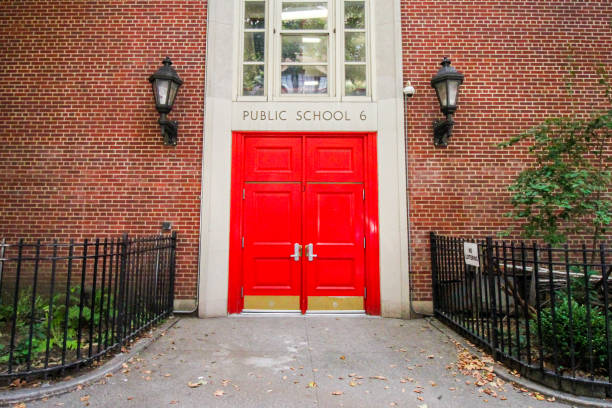 Public school New York, USA - August 7, 2018: the red door of a public school closed during the summer entrance sign stock pictures, royalty-free photos & images