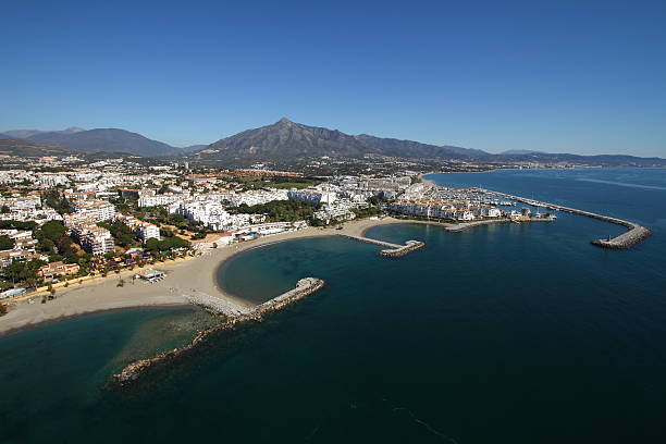 Puerto Banus Landscape Aerial perspective of Marbella´s coastline, in southern Spain. Puerto Banus is on foreground and the mountain of La Concha on the background marbella stock pictures, royalty-free photos & images
