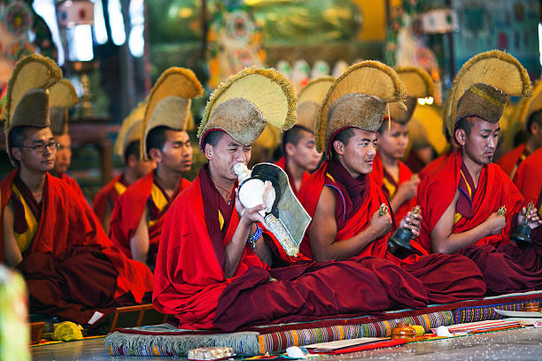 Puja Ceremony, Nepal Kathmandu, Nepal - March 2, 2010: Buddhist monks playing music during Puja ceremony at Shechen monastery. tibetan ethnicity stock pictures, royalty-free photos & images