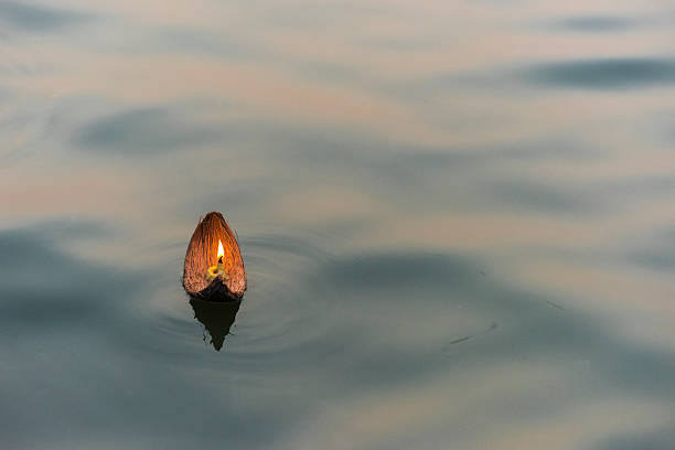 Puja In Varanasi, India Candle Floating In The Ganges In Varanasi, India ganges river stock pictures, royalty-free photos & images