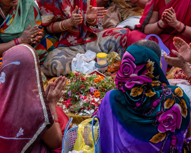 Puja October 14,2017. Varanasi,India. Hindu women chanting and counting mantras for offering in the Ganges river at Varanasi ghat. Selective focus is used. chhath stock pictures, royalty-free photos & images