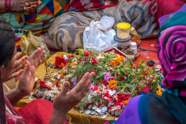 Puja October 14,2017. Varanasi,India. Hindu women chanting and counting mantras for offering in the Ganges river at Varanasi ghat. Selective focus is used. chhath stock pictures, royalty-free photos & images