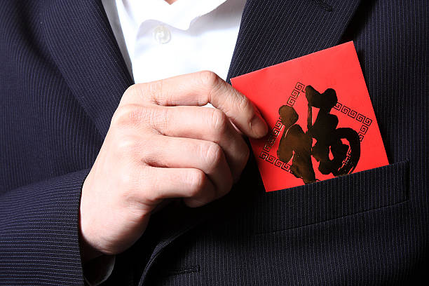 Pulling out a red pocket from suit stock photo