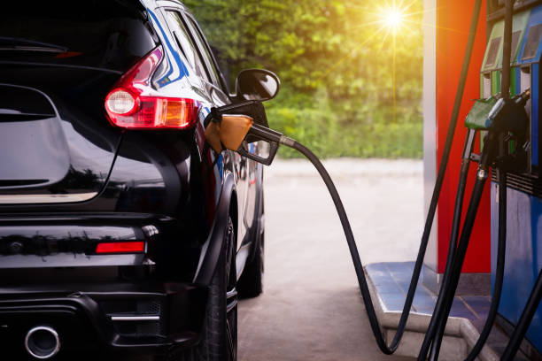 pumping gasoline fuel in car. - gasoline imagens e fotografias de stock