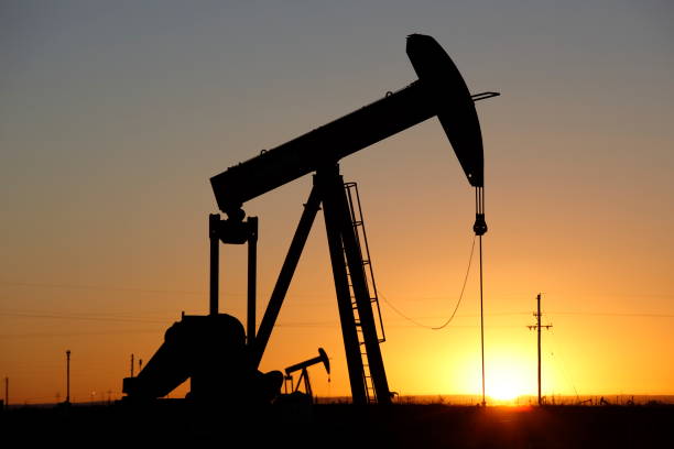 Pumpjacks, the sunset of New Mexico oil field stock photo