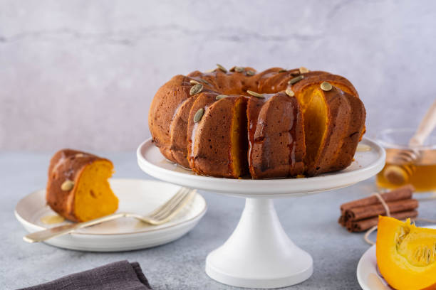 Pumpkin cake with honey on a gray background. Copy space. stock photo
