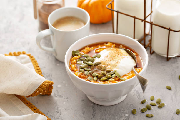 Pumpkin oatmeal with yogurt and pumpkin seeds stock photo