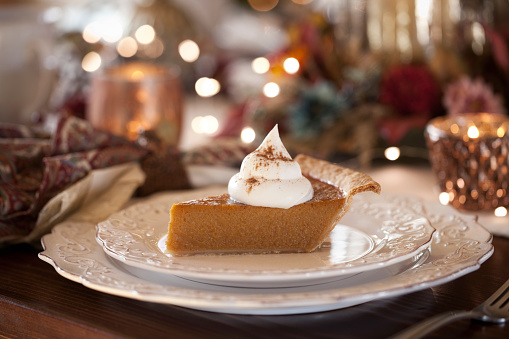 Thanksgiving holiday pumpkin pie with whipped topping.