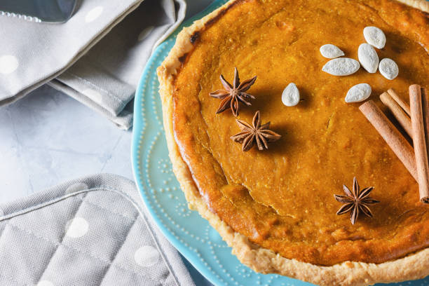 Pumpkin pie with cinnamon and anise. Cropped photo from above. Tasty dessert stock photo