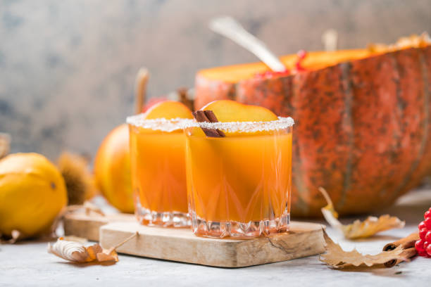 Pumpkin punch or sangria in a big pumpkin. Halloween and Thanksgiving. Traditional autumn, winter drinks and cocktails stock photo