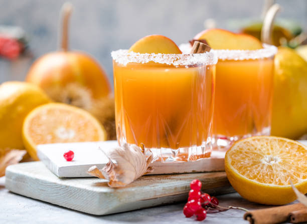 pumpkin punch or sangria in a glass with apple, cinnamon. Halloween and Thanksgiving. Traditional autumn, winter drinks and cocktails stock photo