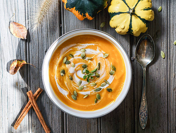 Pumpkin soup with cream and pumpkin seeds. stock photo