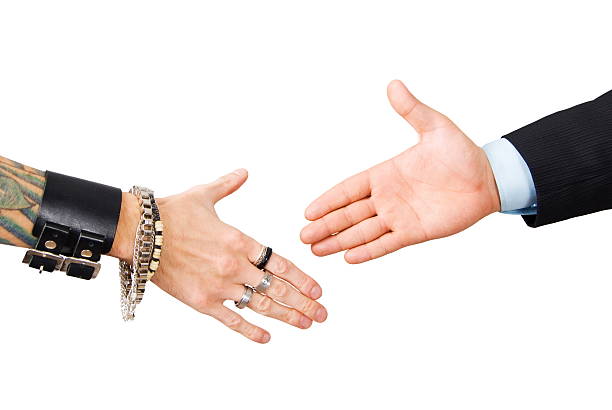 punk man and businessman hand shake isolated on white background stock photo